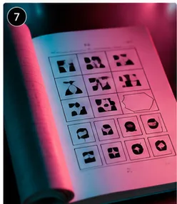 Close-up of a Raven's Progressive Matrices test booklet showing the abstract pattern grid